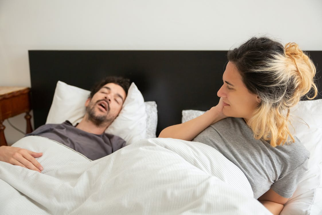 A man sleeping and snoring.