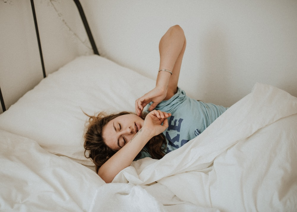 a woman sleeping in bed.